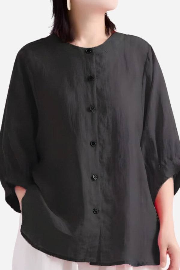 Relaxed loose breathable linen blouse in black with button-down front and three-quarter sleeves.