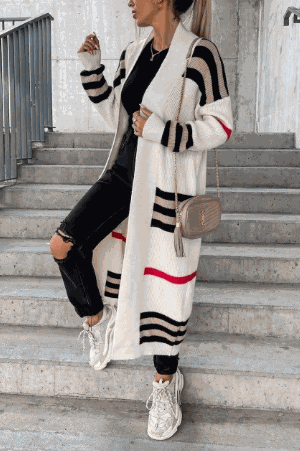 Cozy striped long knitted cardigan with oversized fit and soft fabric on model wearing black outfit