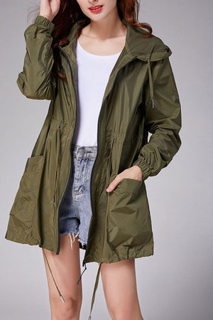 Travel ready outdoor raincoat windbreaker in olive green, lightweight waterproof jacket with hood and pockets.