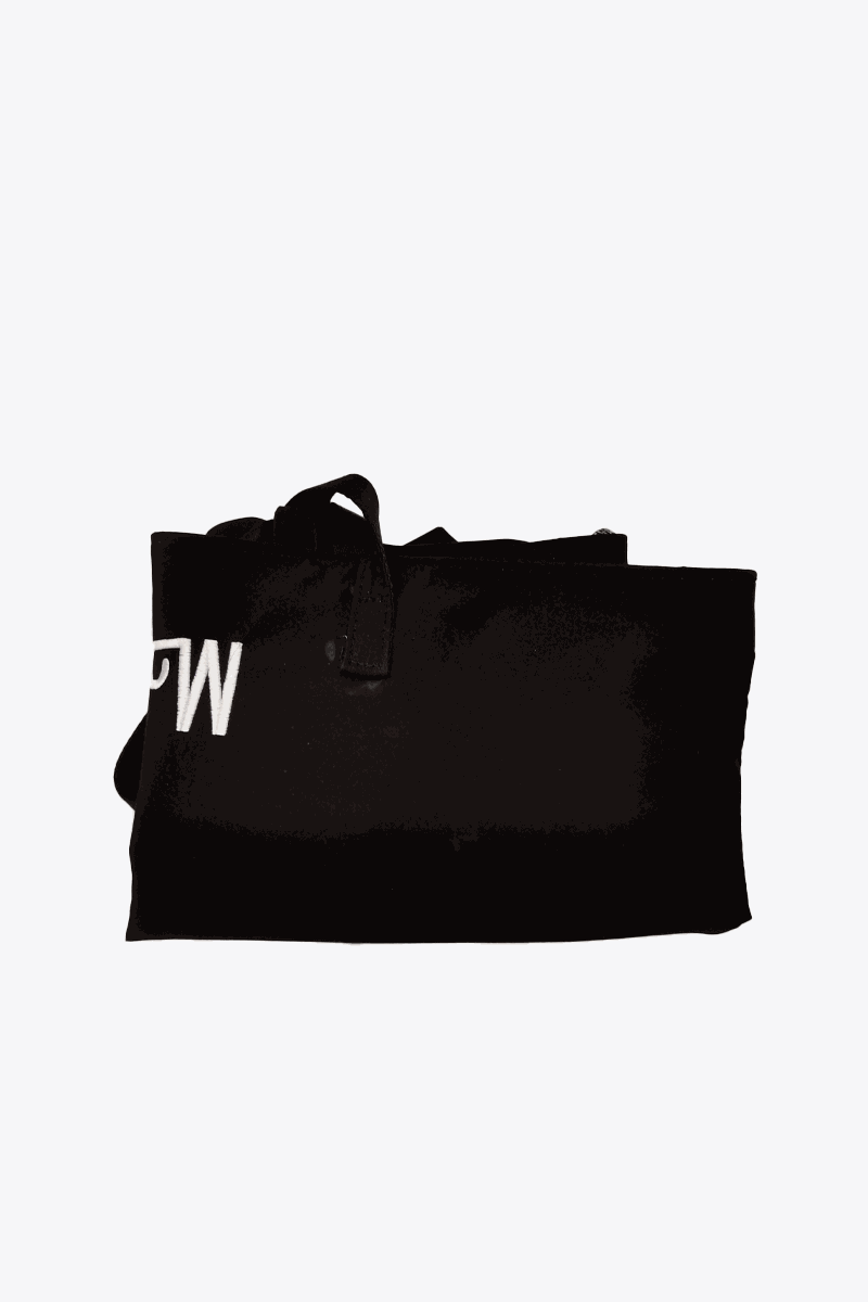 Folded black waterproof travel bag with sturdy handles and minimalist design