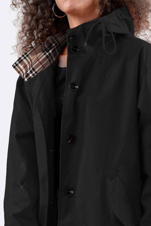 Travel-smart waterproof hooded windbreaker in black with adjustable hood and beige plaid lining.