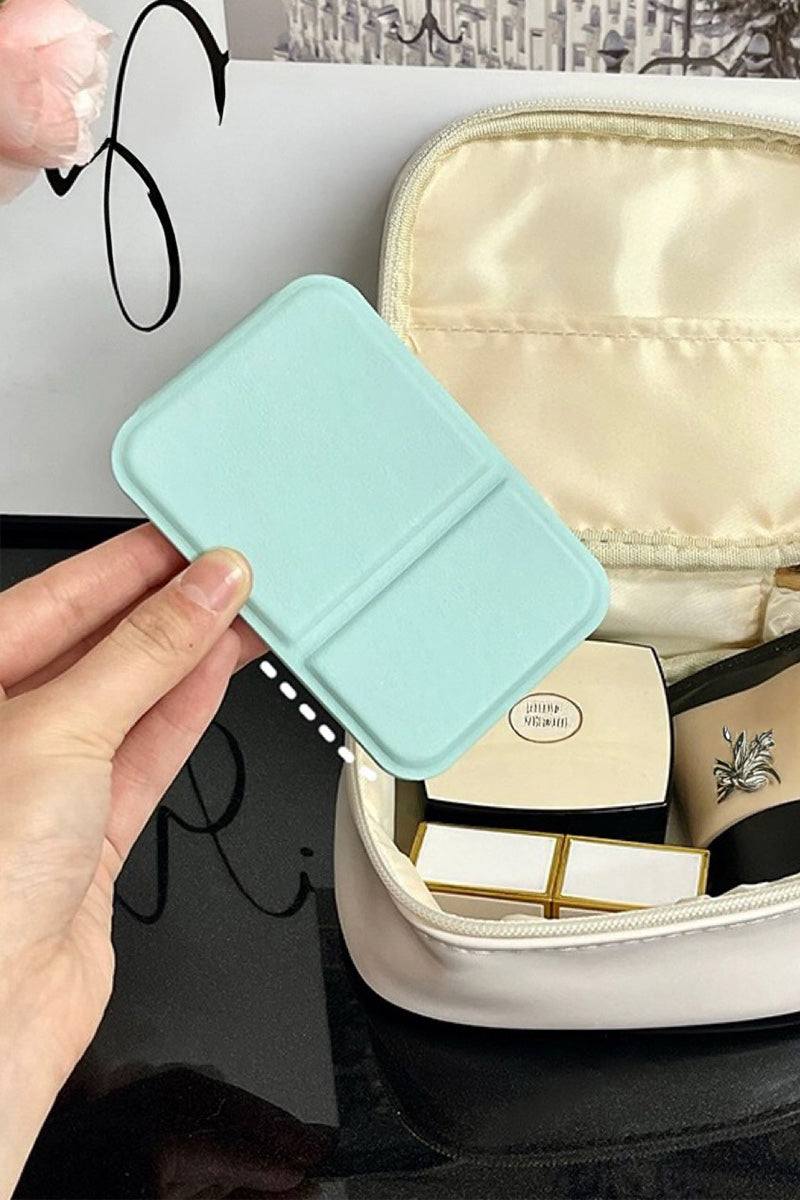 Compact travel pocket mirror with durable PU leather cover in light blue, perfect for on-the-go touch-ups.