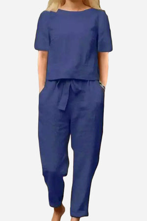 Woman wearing a navy blue cotton-linen blend relaxed fit two-piece set with short sleeves and drawstring pants