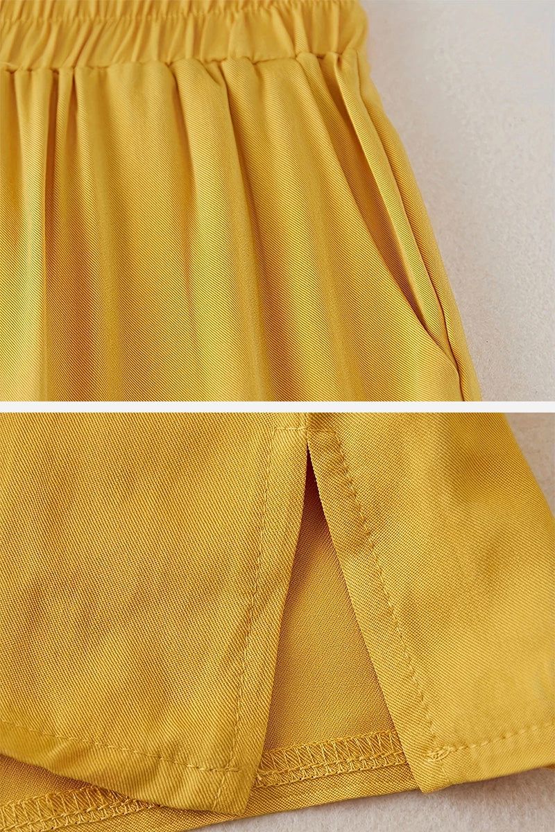 Close-up of mustard yellow breathable cotton wide-leg pants from 100 cotton two-piece set with elastic waistband and side slit hem detail