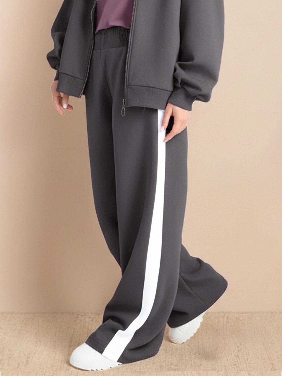 Two-piece easy airport lounge set with zip-front jacket and wide-leg pants in soft cotton-blend fabric designed for travel comfort and wrinkle resistance