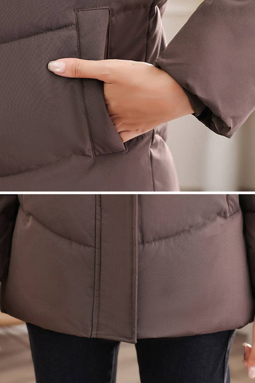 Close-up of hand in pocket on brown Everyday Warmth Coat showing mid-length, lightweight thermal insulation.