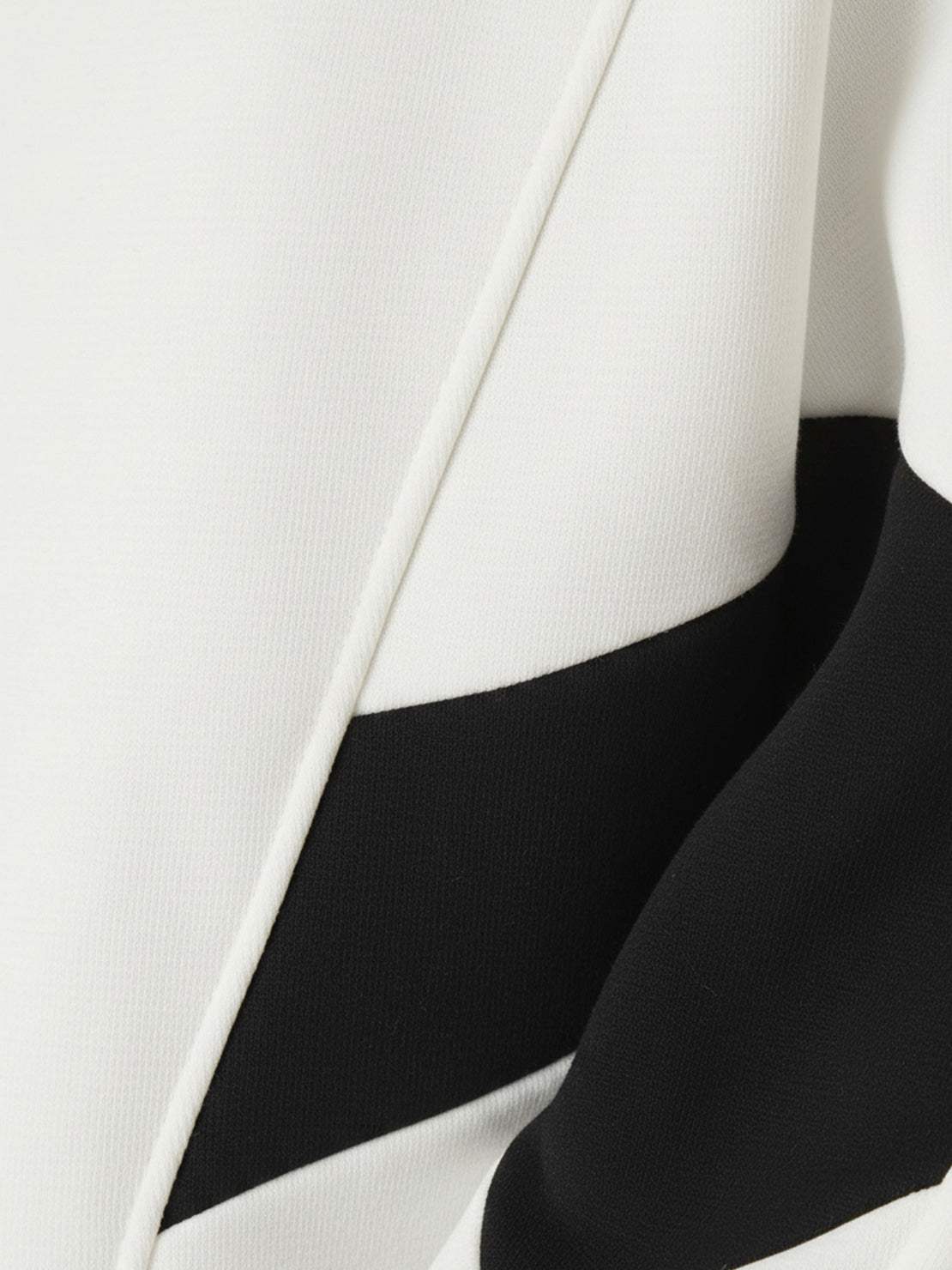 Woman wearing a Colorblock Comfort Tracksuit with contrast curved panels and stand collar jacket