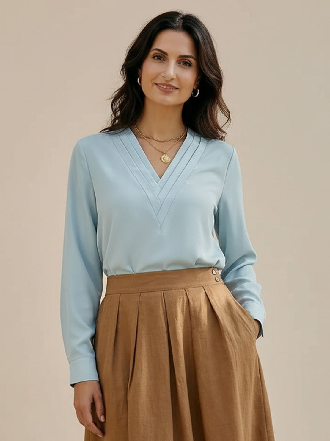 White pleated V-neck long-sleeve blouse with button cuffs and relaxed fit