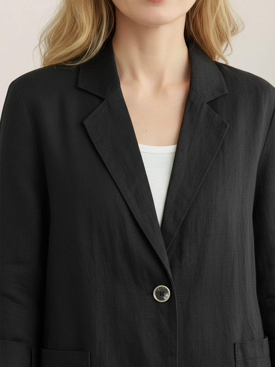 Hip-length cotton-linen blazer with notch lapels and two-button front closure