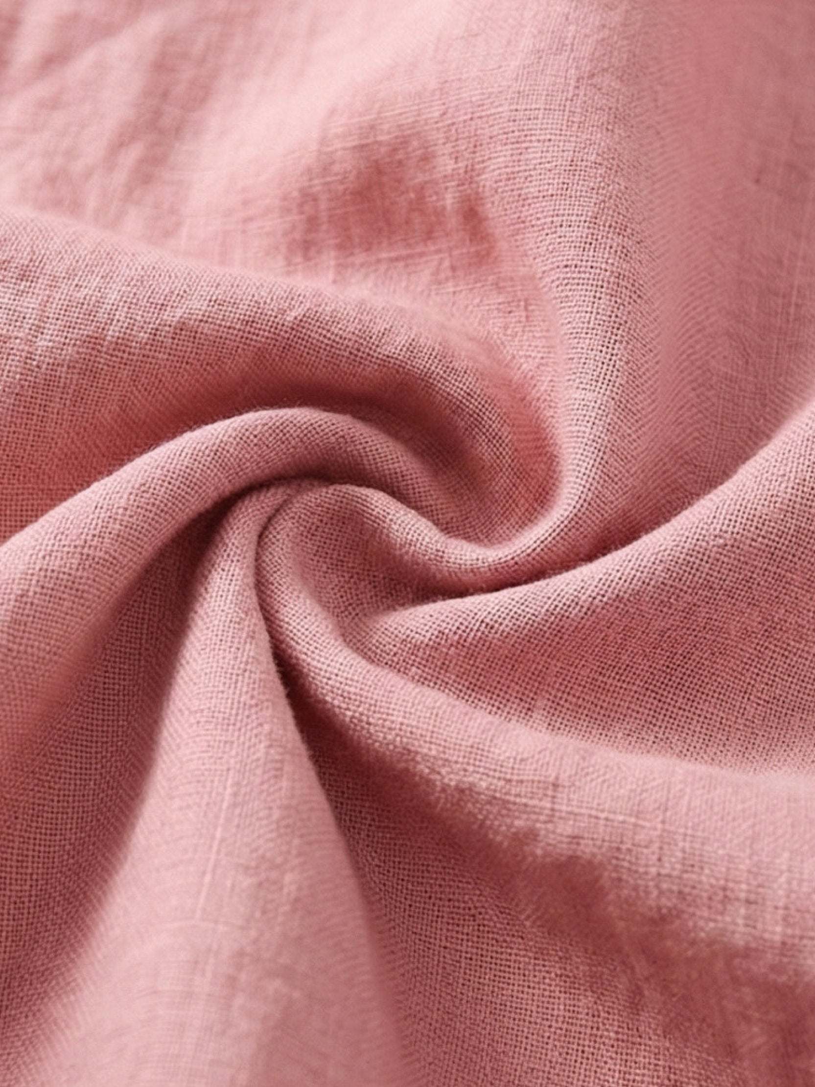 100% linen relaxed midi dress with short sleeves, large front pockets, and side slits for comfort and style