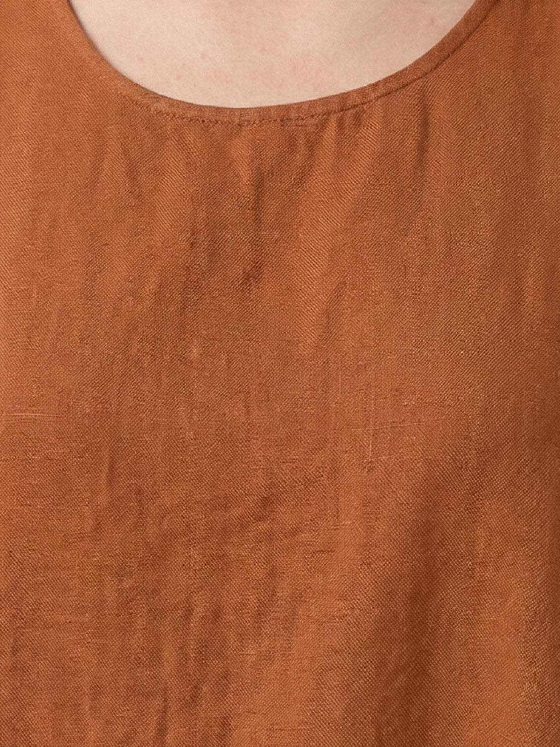 Woman wearing a 100% cotton linen sleeveless maxi dress with round neckline and flowing ankle-length silhouette