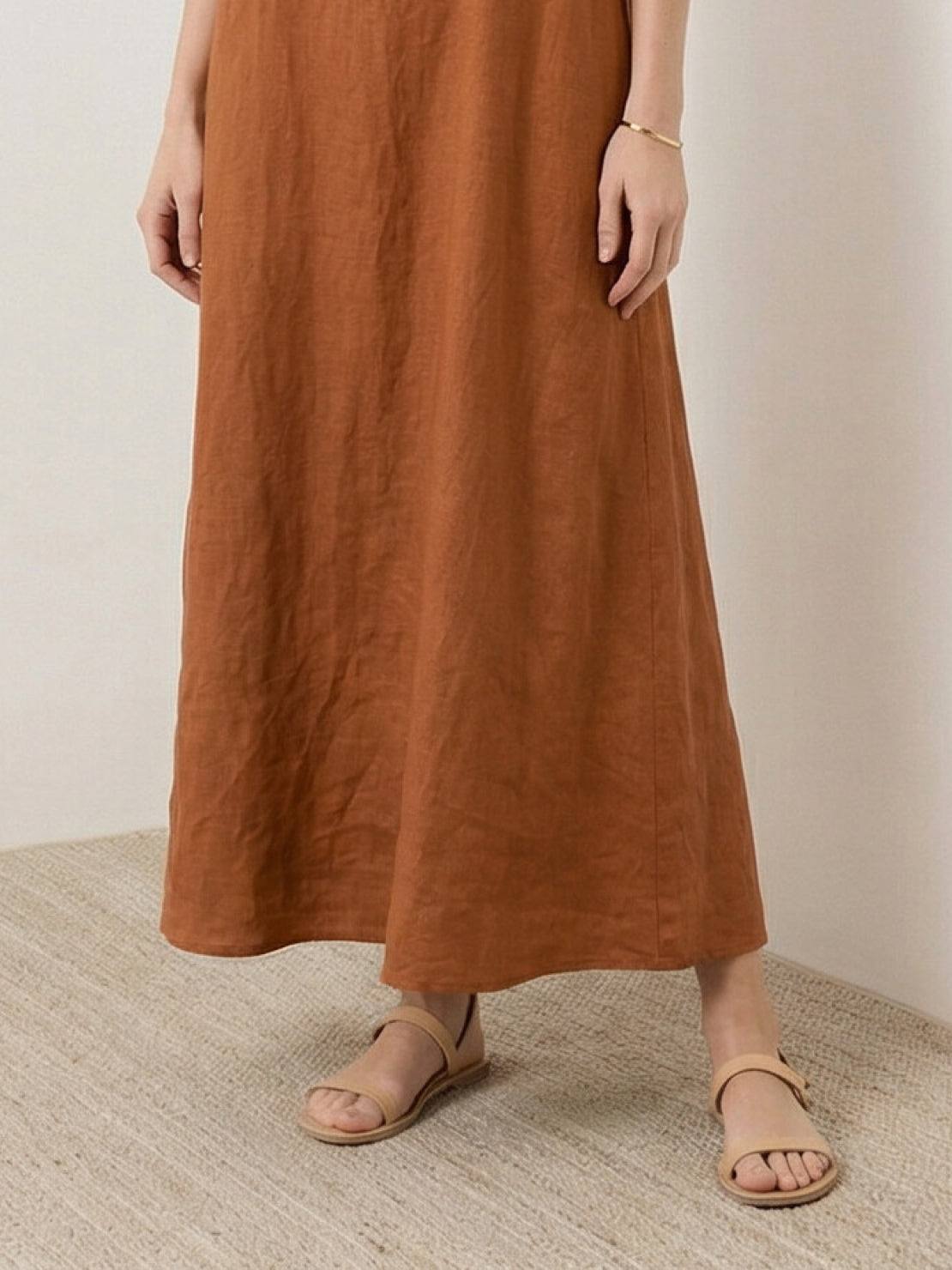 Woman wearing a 100% cotton linen sleeveless maxi dress with round neckline and loose ankle-length fit