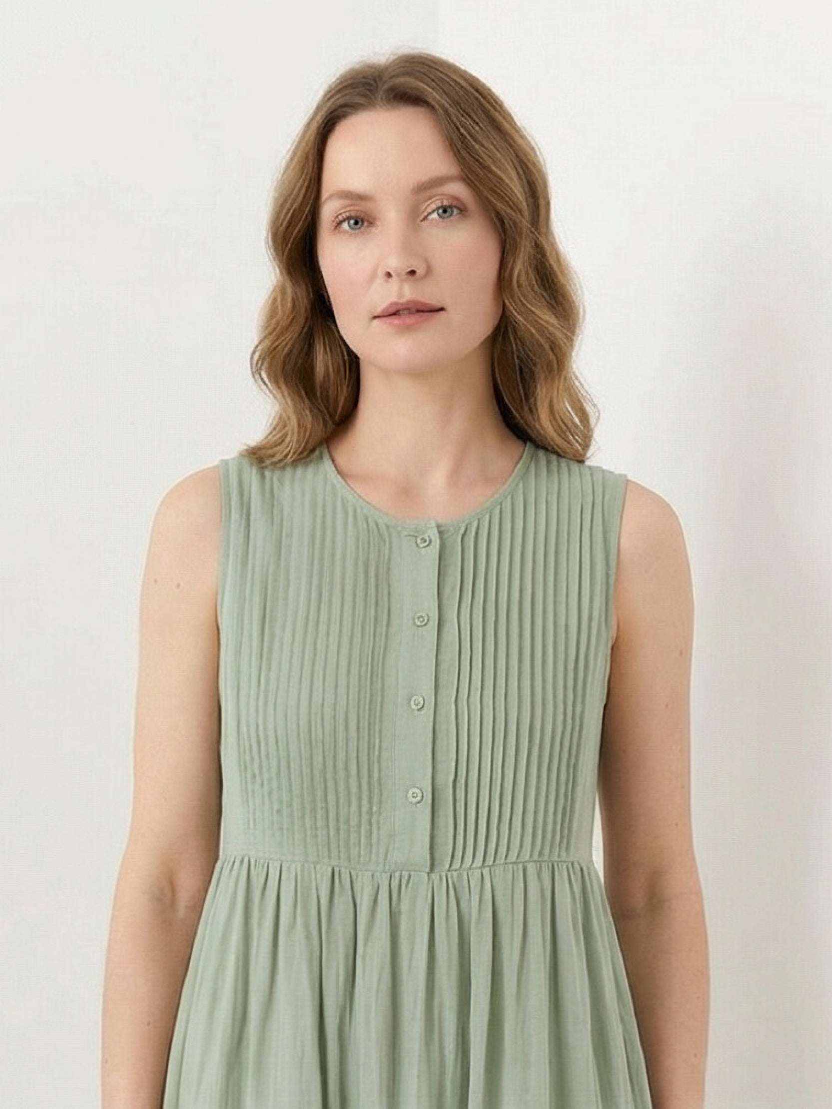 Sleeveless cotton linen pleated midi dress with pintuck bodice and full A-line skirt in white