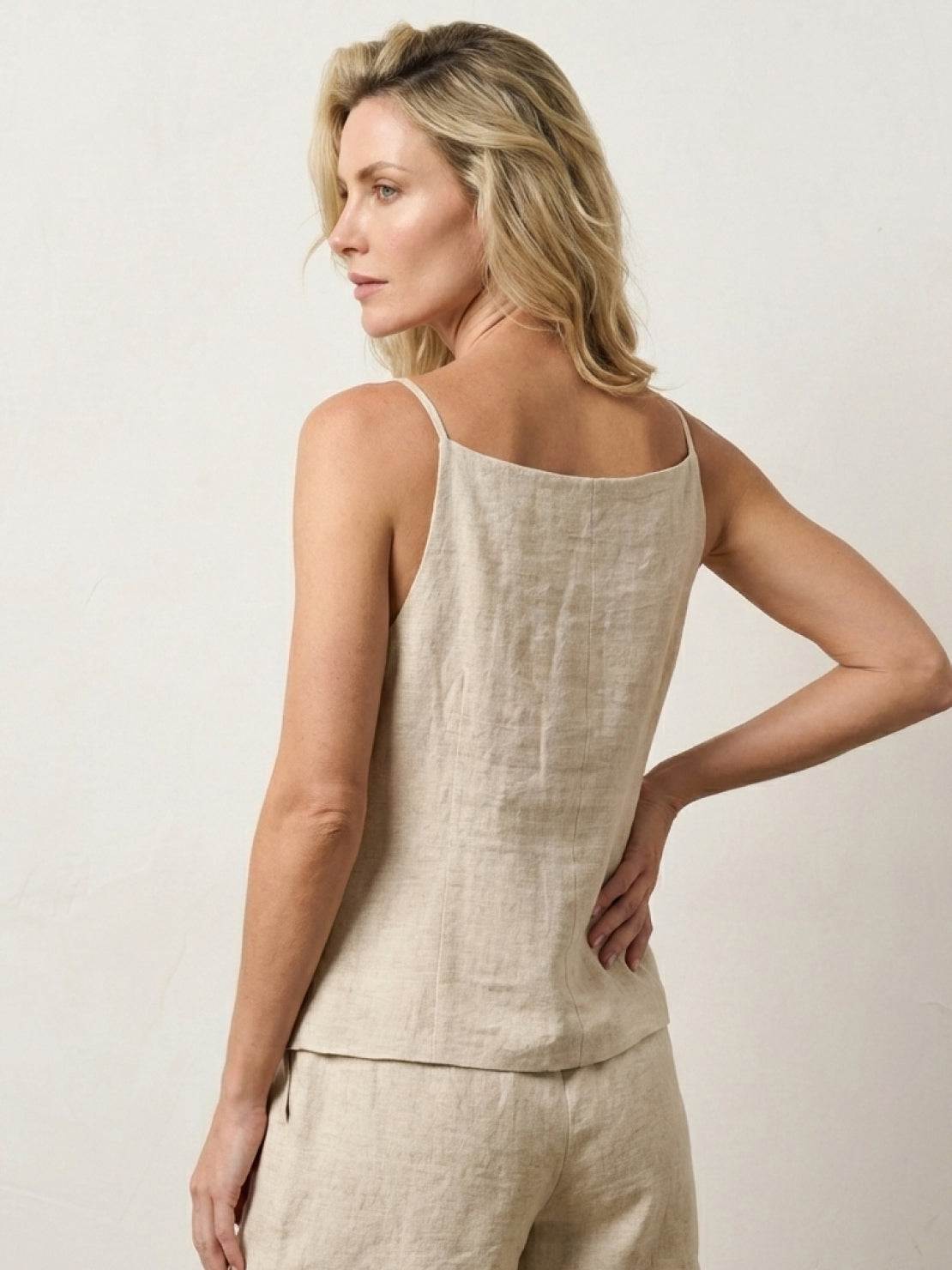 100% linen yarn-dyed vest with square neckline, spaghetti straps, button-front, curved hem, and welt pockets