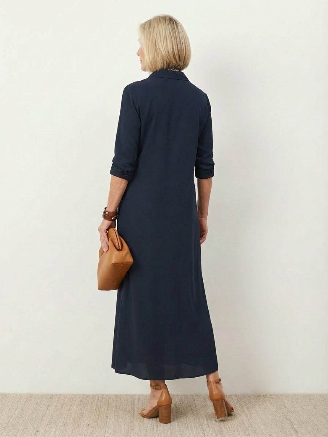 Wrinkle-free maxi button-down dress with point collar, chest pockets, side slits, and roll-up sleeves in relaxed silhouette