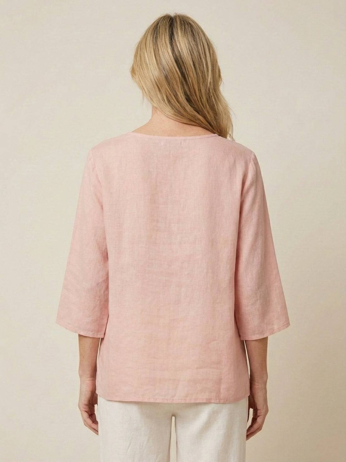 100% cotton linen hand-embroidered shirt with 3/4 flared sleeves and asymmetric hem featuring detailed botanical embroidery