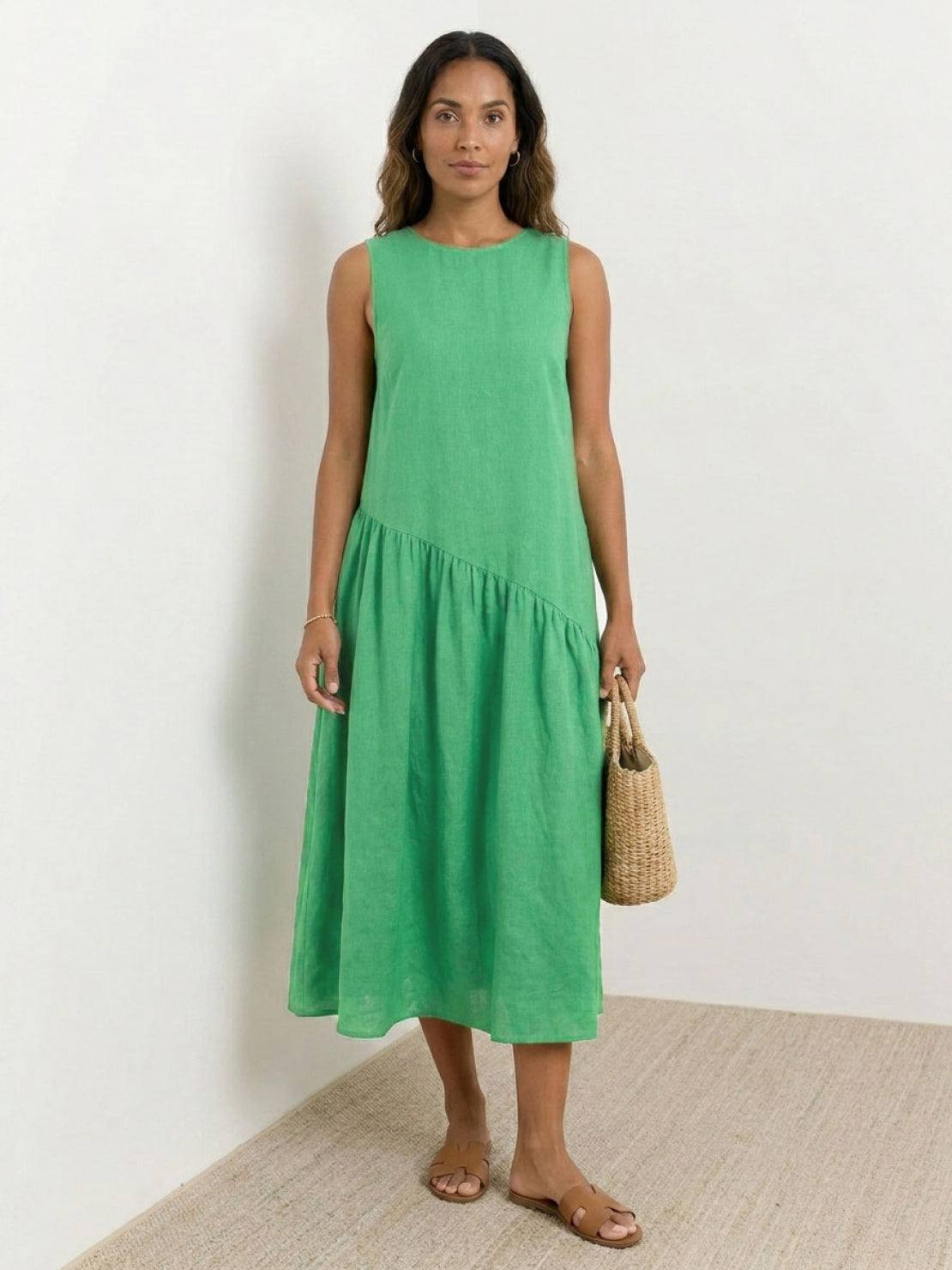 Woman wearing a cotton-linen summer midi dress with tiered skirt and relaxed drop-waist silhouette