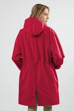 Red water resistant oversized hooded windbreaker jacket on woman from back view