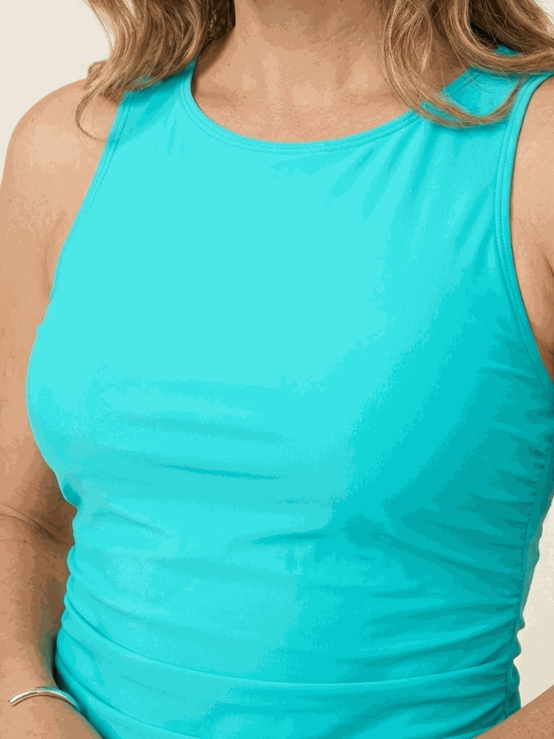 High-neck ruched tankini set with printed top and solid bottom, featuring side ruching and built-in shelf bra