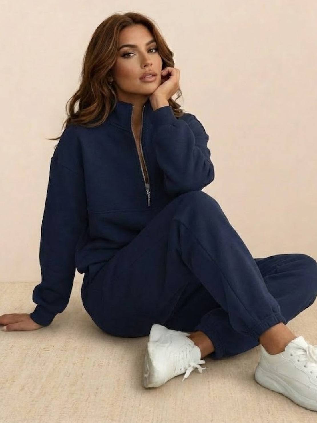 Woman wearing gray cotton-blended two-piece tracksuit with high collar and deep zipper outdoors