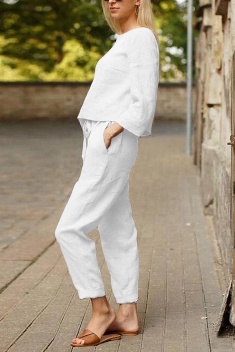 Woman wearing white relaxed longline top and fluid wide-leg pants from Cotton-Linen Monochrome Capsule set outdoors