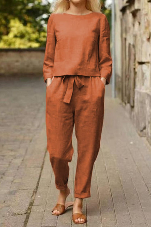 Woman wearing rust-colored cotton-linen monochrome longline top and wide-leg pants set with relaxed fit and tie waist