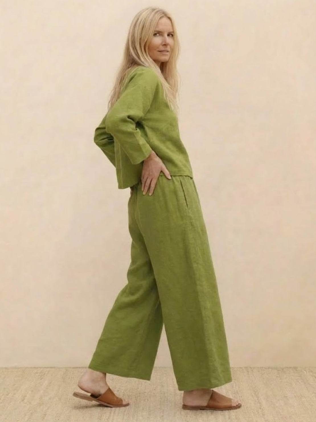 Woman wearing a loose solid color two-piece set with a round-neck top and wide-leg pants.