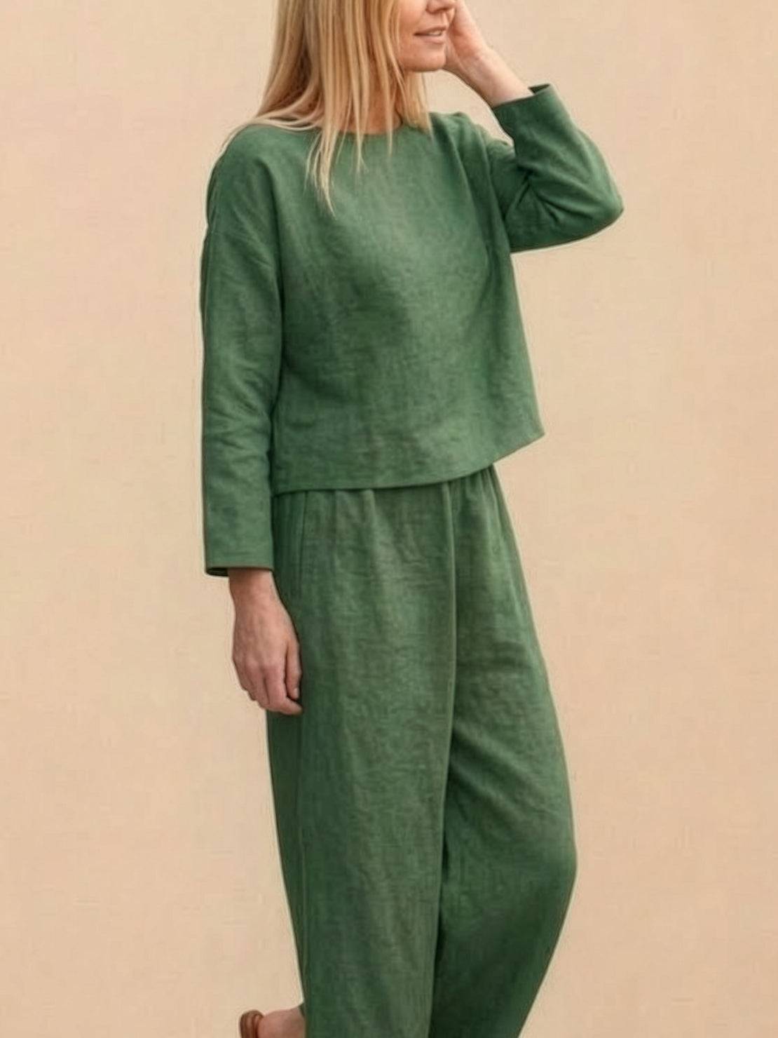 Woman wearing loose solid color two-piece set with wide-leg pants and pullover top
