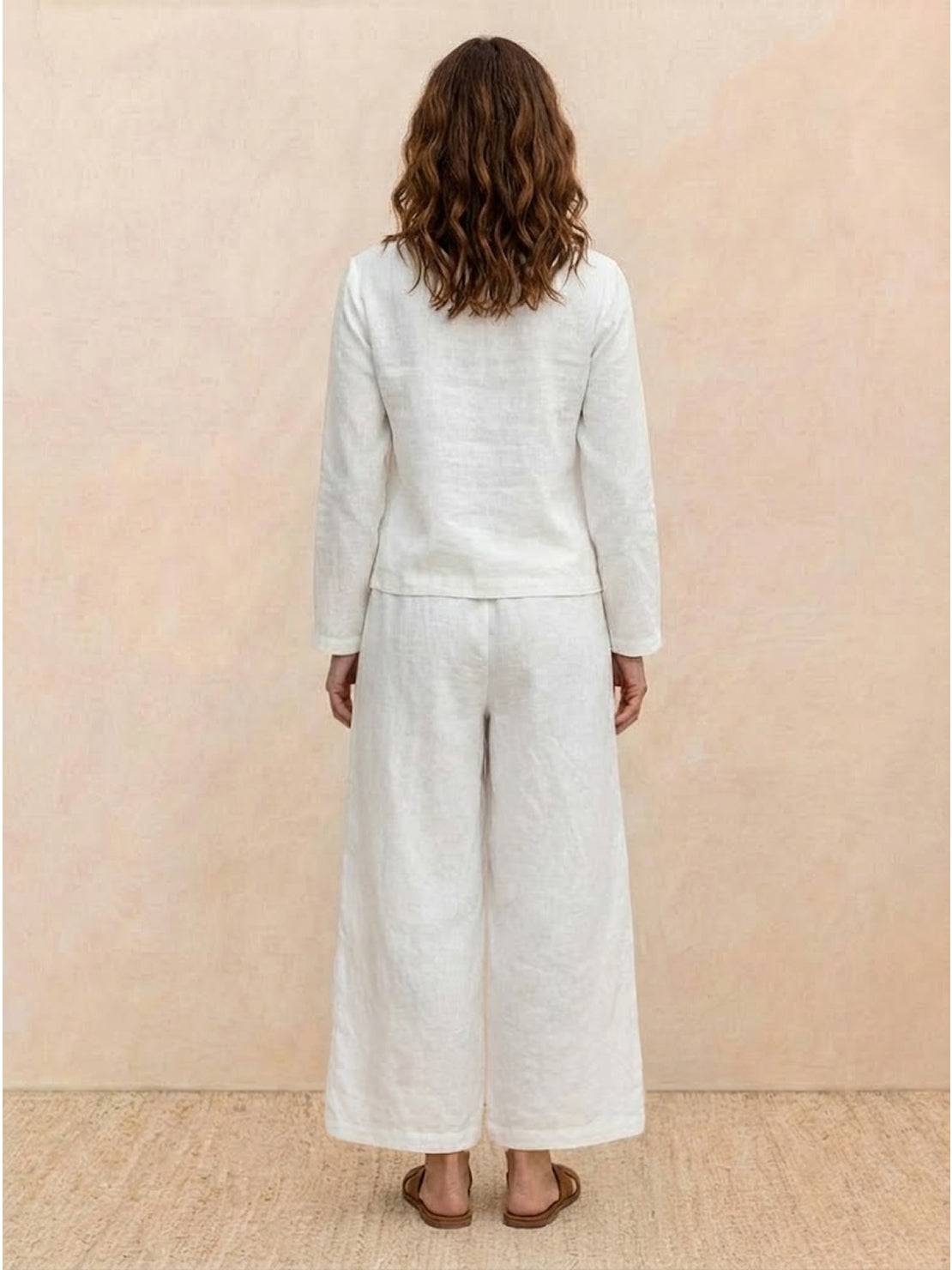 Woman wearing loose solid color two-piece set with wide-leg pants and pullover top