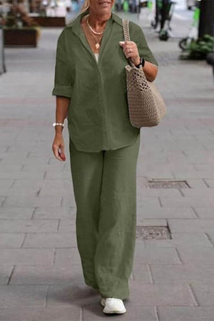 Woman wearing oversized 100% cotton olive green shirt and wide-leg pants co-ord set walking outdoors