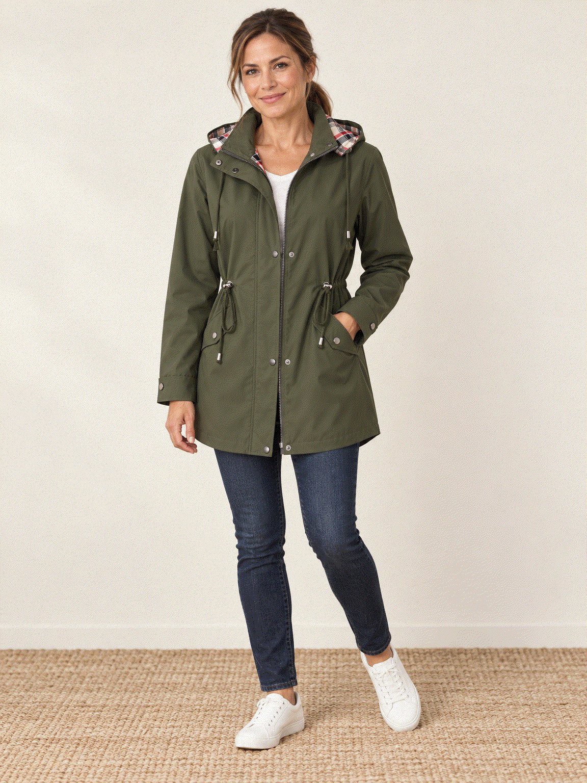 Plaid-lined hooded rain jacket with waterproof shell and adjustable waist cinch