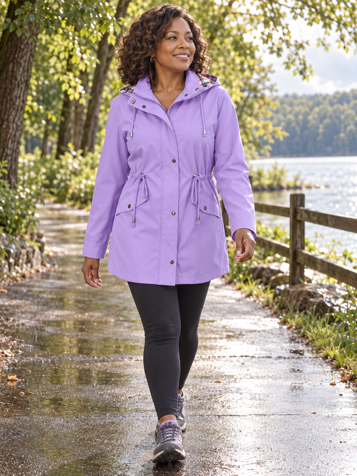 Plaid-lined hooded rain jacket with waterproof shell and adjustable drawstring waist
