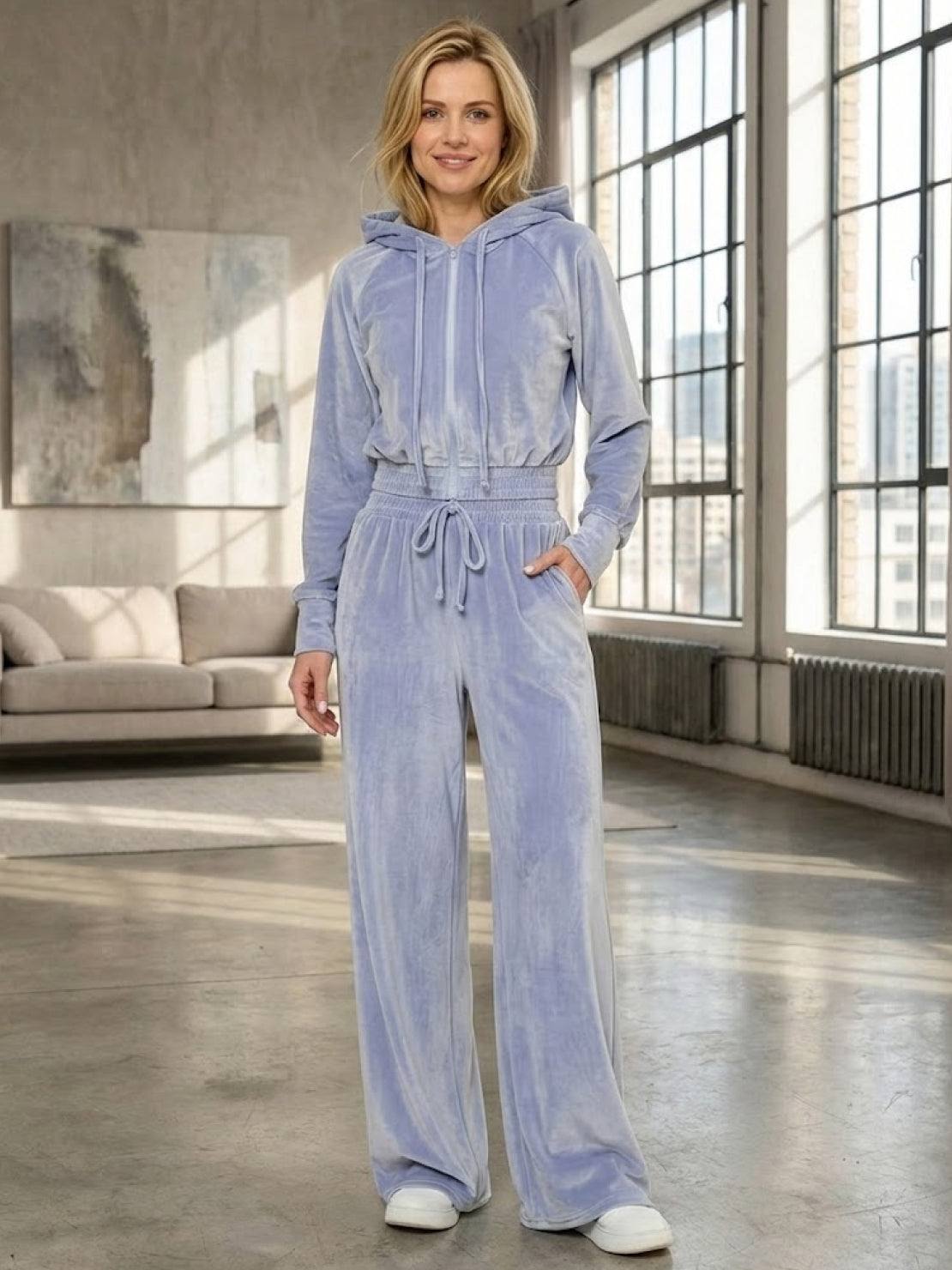 woman wearing modern cropped velour tracksuit set with high-waist pants in vibrant color
