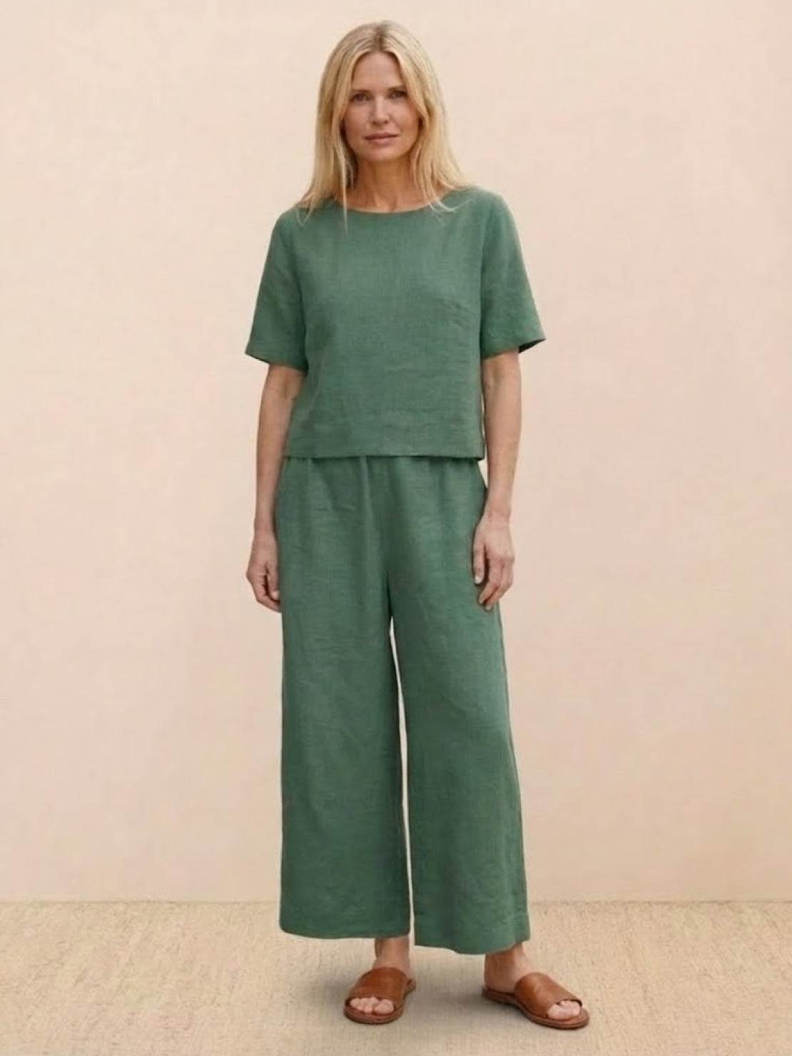 Woman wearing green loose fit co-ord set with wide-leg pants and short sleeve top