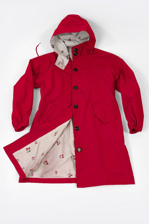 Red oversized Rain Couture Windbreaker with hood and floral patterned interior lining.