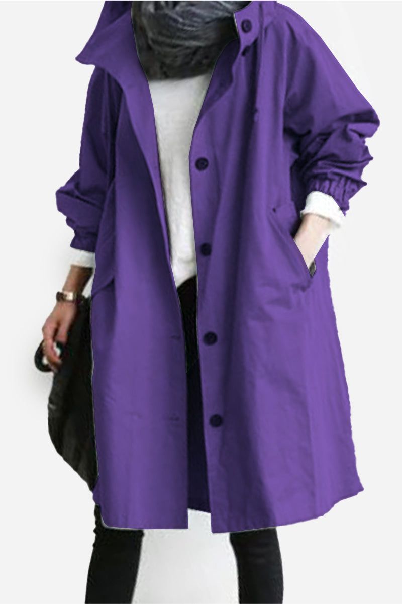 Purple oversized Rain Couture Windbreaker water-resistant jacket with buttons and pockets worn over casual outfit