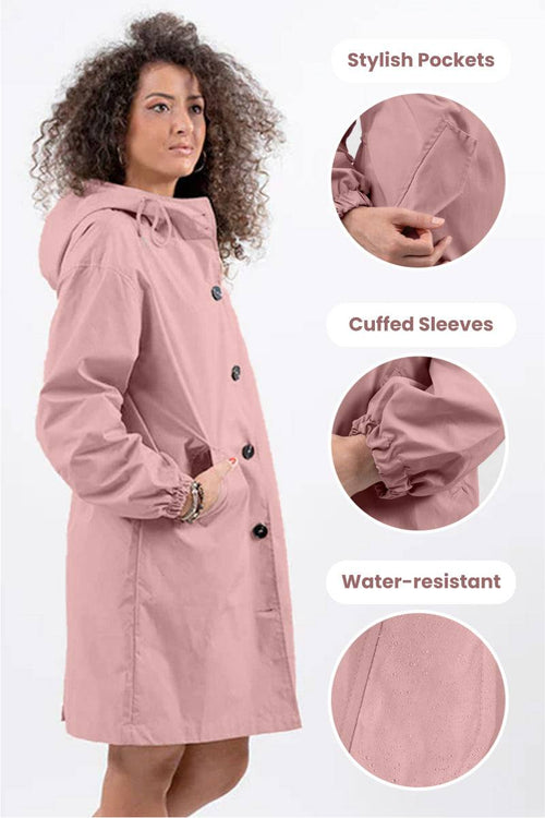 Woman wearing pink oversized Rain Couture Windbreaker with hood, stylish pockets, cuffed sleeves, and water-resistant fabric.