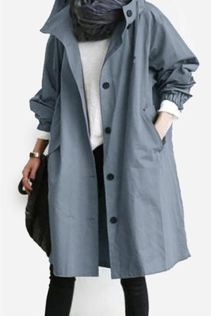 Trendy oversized Rain Couture Windbreaker in blue, lightweight and water-resistant jacket with adjustable hood and multiple pockets.