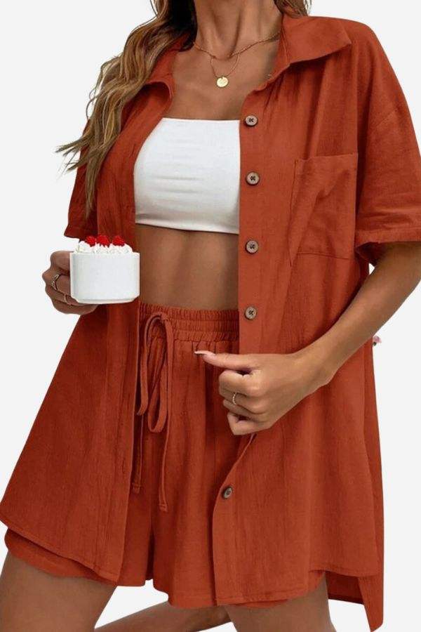 woman wearing Sunny Day Vibrance rust-colored button-up shirt and matching shorts two-piece set with white crop top underneath