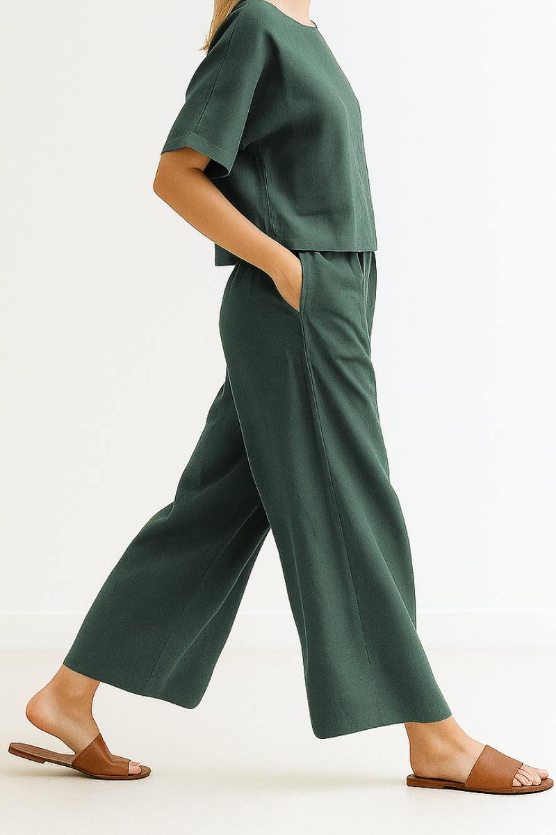 Green loose fit co-ord set with wide-leg pants and relaxed short-sleeve top, styled with brown slide sandals