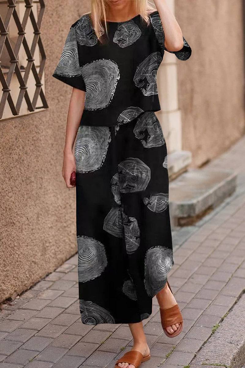 woman wearing black loose fit co-ord set with gray circular patterns and wide-leg pants on street