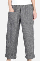 High waist striped comfort pants with large patch pockets and rolled cuffs on a female model