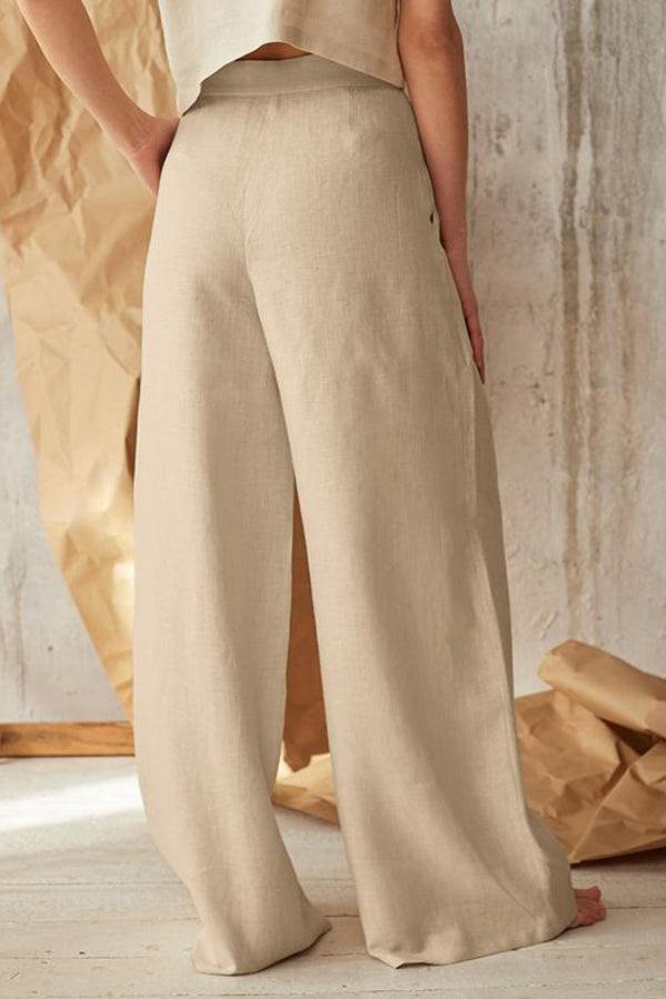 Button front high waist beige palazzo pants with wide legs and lightweight fabric.