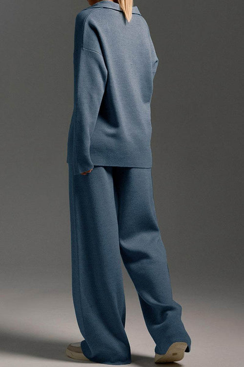 Back view of a model wearing a blue Plush & Preppy Camel Two-Piece Set with wide-leg pants and a loose long-sleeve top against a gray background