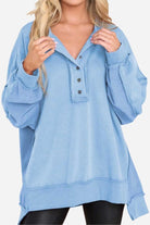 Light blue oversized urban sweatshirt with raw seam details and slouchy sleeves.
