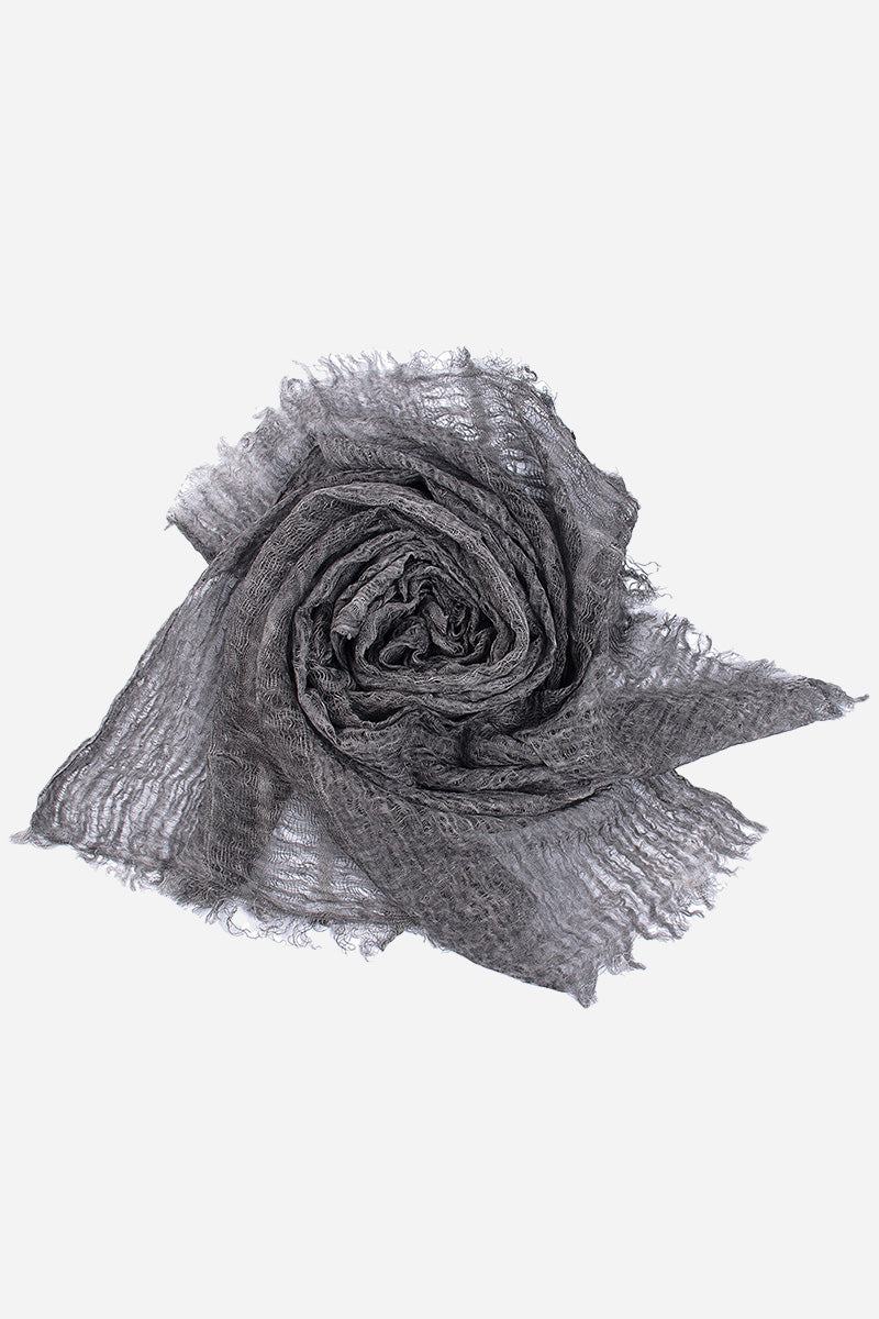 Rolled lightweight linen scarf with frayed edges in gray color on white background