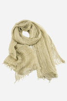 beige lightweight linen scarf with frayed edges on white background