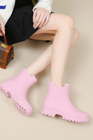Pink non-slip rain boots with SuperGrip soles, waterproof and lightweight for comfort and easy cleaning.