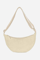 Beige corduroy shoulder bag with adjustable strap and zip closure, lightweight and roomy design.