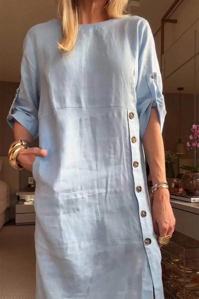 Light blue Pure Cotton Elegance dress with button details and rolled-up sleeves worn by a woman indoors